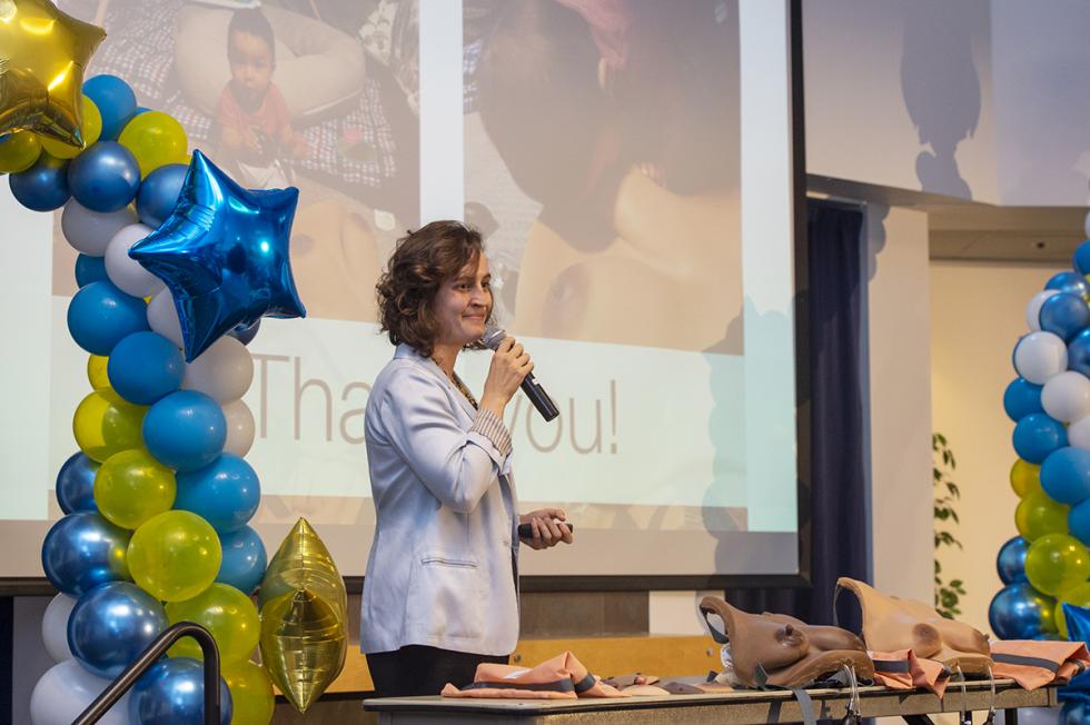 Woman student pitching startup in business competition.