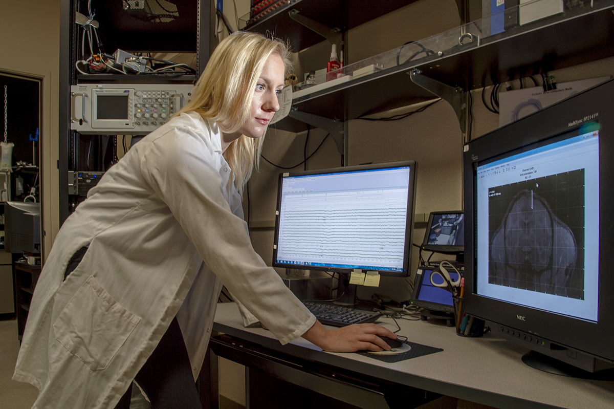 doctoral candidate in her lab with computer screens