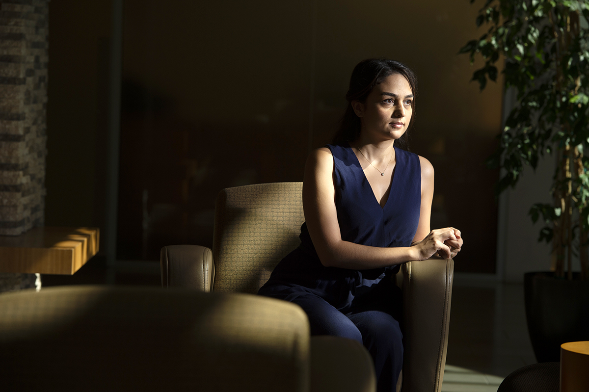 UC Entrepreneurship Academy Ipek Bahceci sitting on a chair in a dark room with sunlight