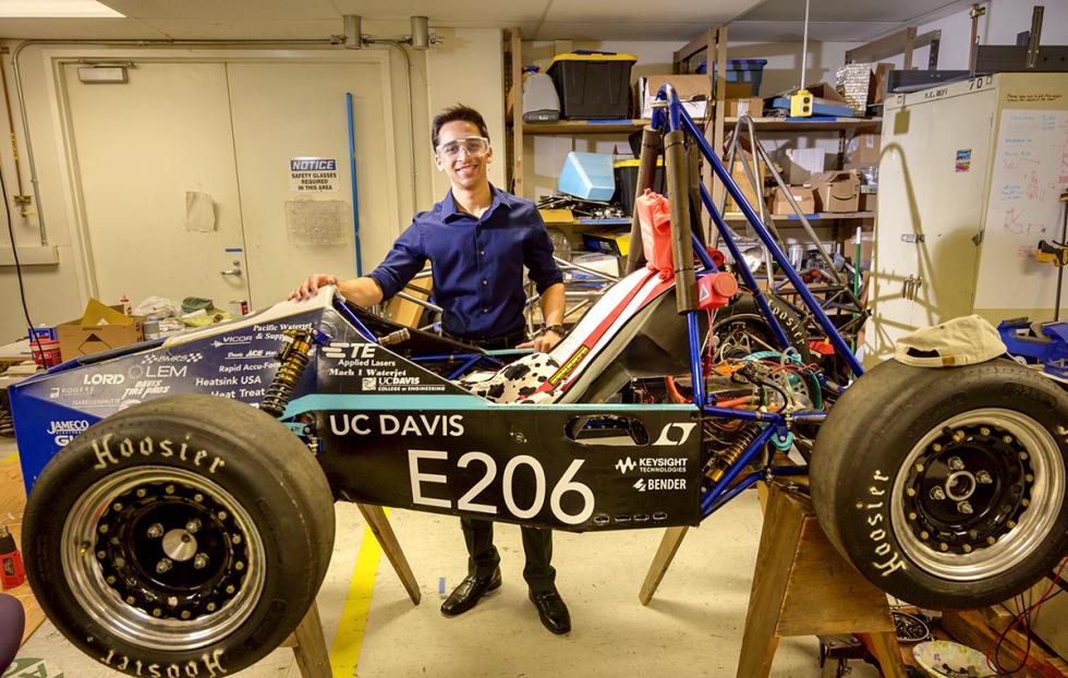 undergraduate man in race car engineering lab