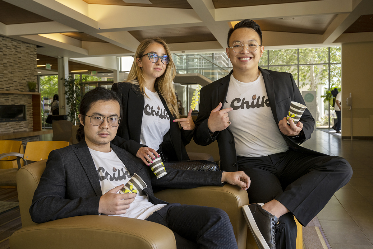 photo of four young entrepreneurs wearing their startup's branded t-shirt
