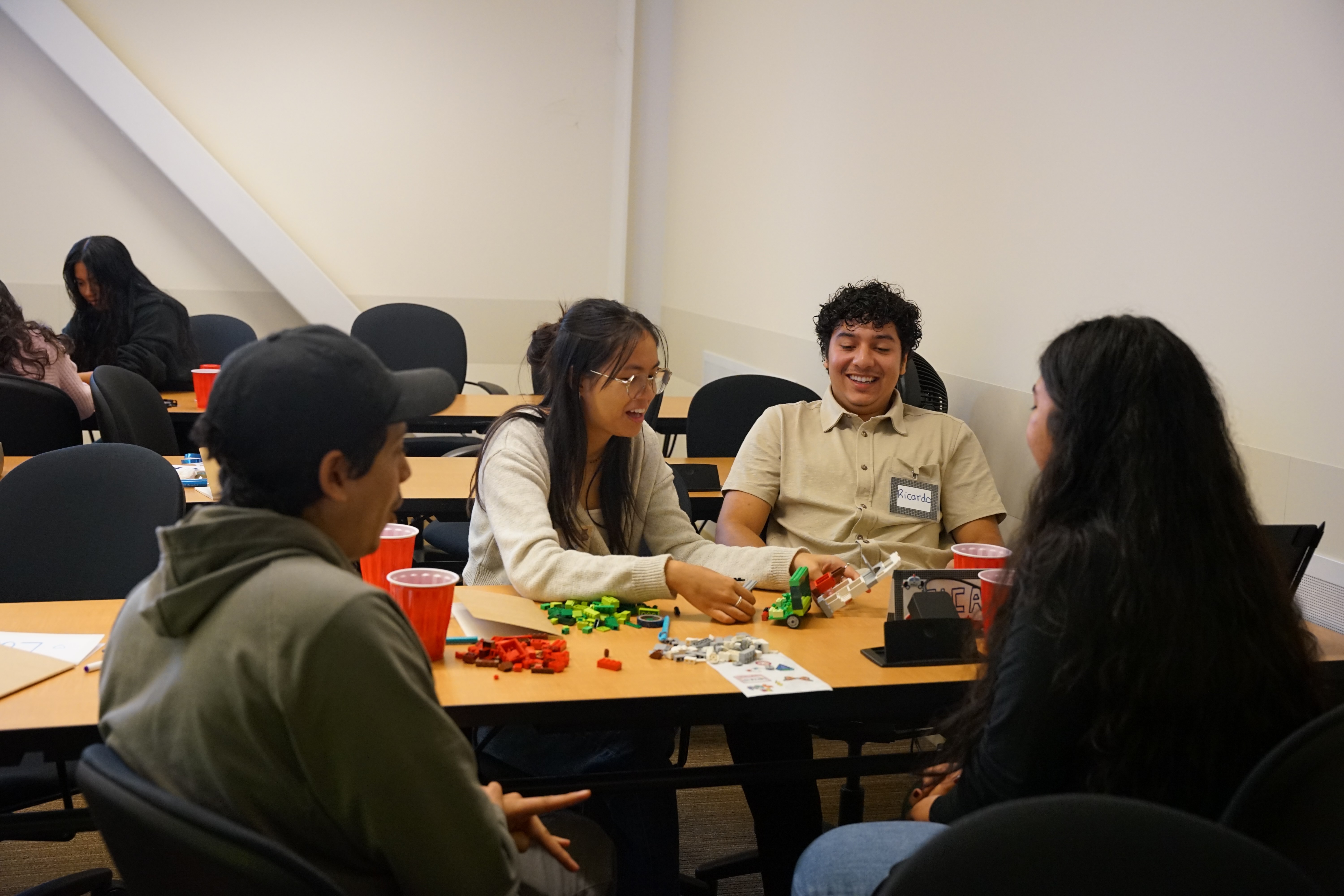 EQUIP students interacting around a table in the classroom