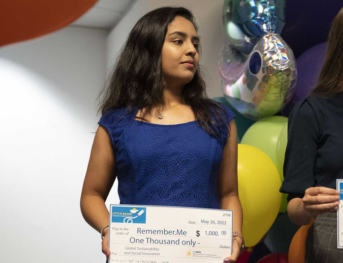 photo of student holding large award check