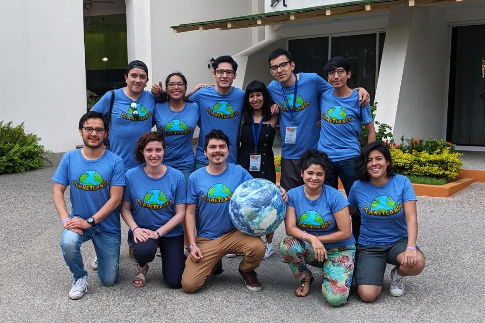 photo of a group of young adults all wearing same t-shirt