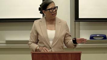 Woman at a podium, speaking