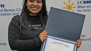An Ideas competition winner holds her certificate