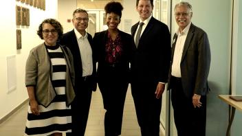 group of people in business attire standing in a hallway