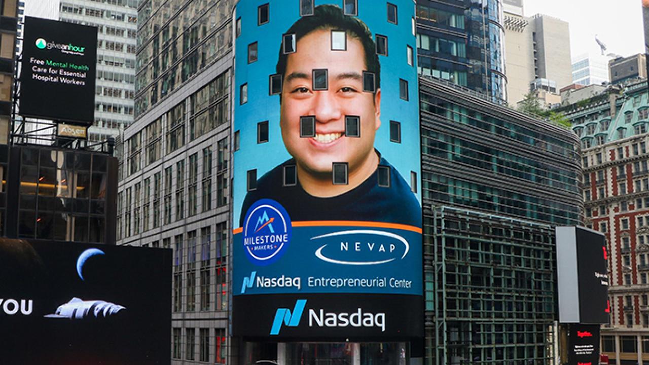 image of face on billboard on street with text "NeVap Nasdaq Entrepreneurial Cetner"