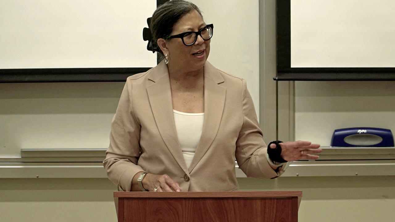 Woman at a podium, speaking