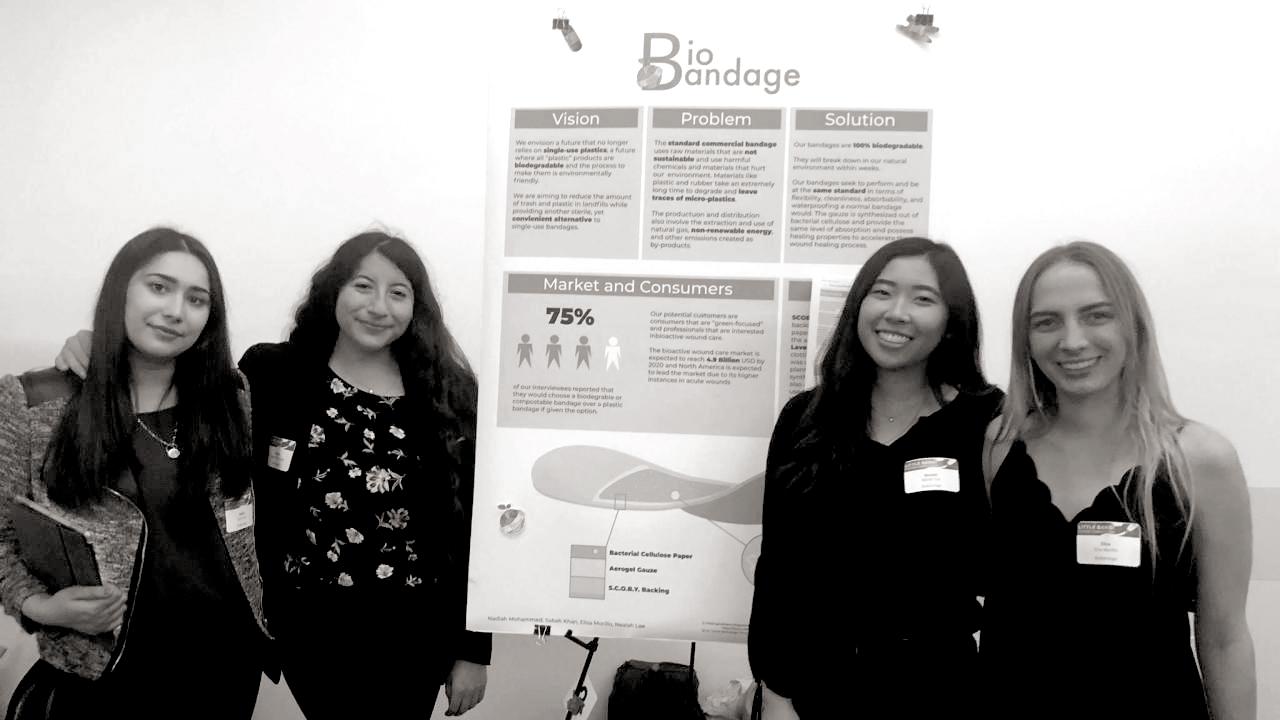 photo of four undergraduate women entrepreneurs participating in a business poster competition