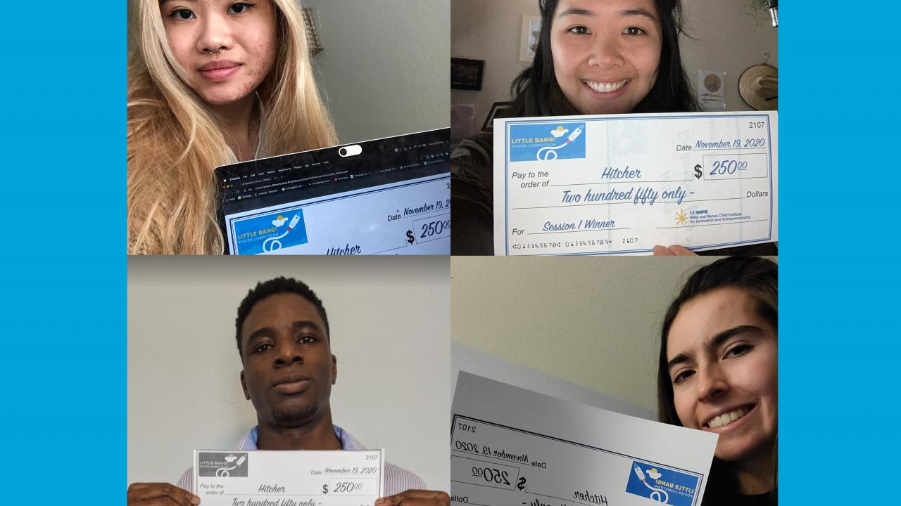 four students holding prize winning checks