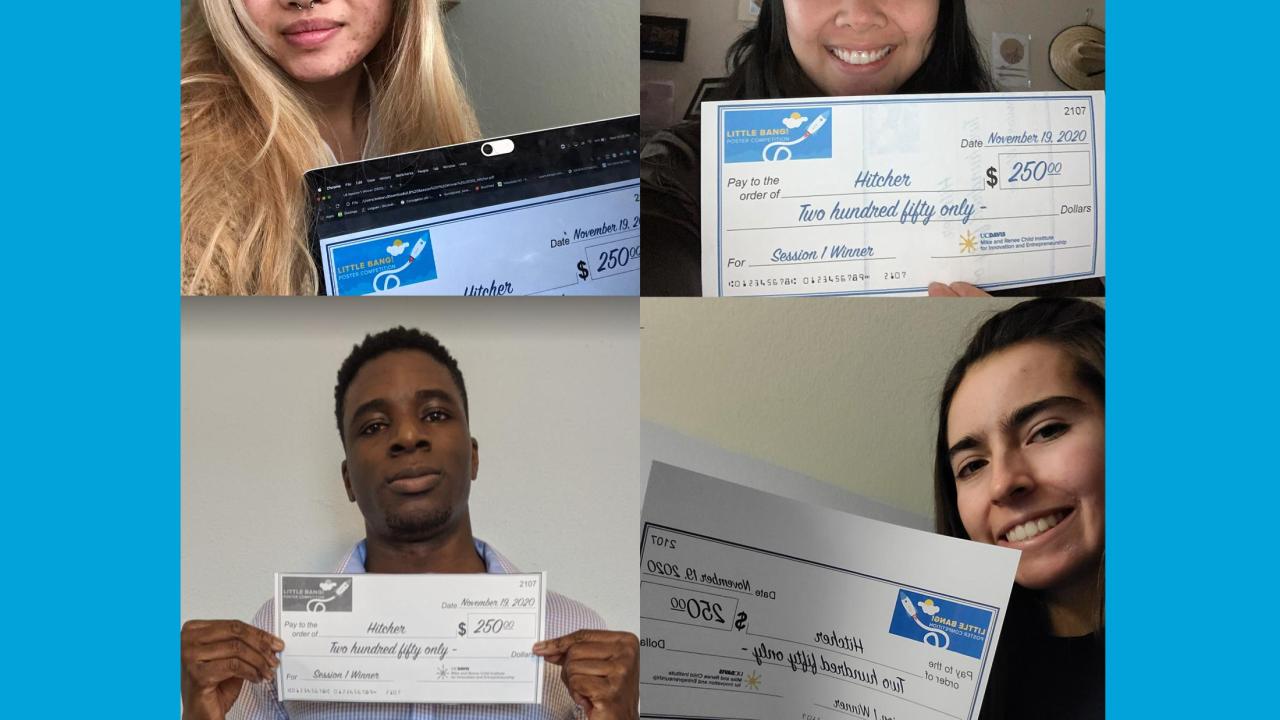 four students holding prize winning checks