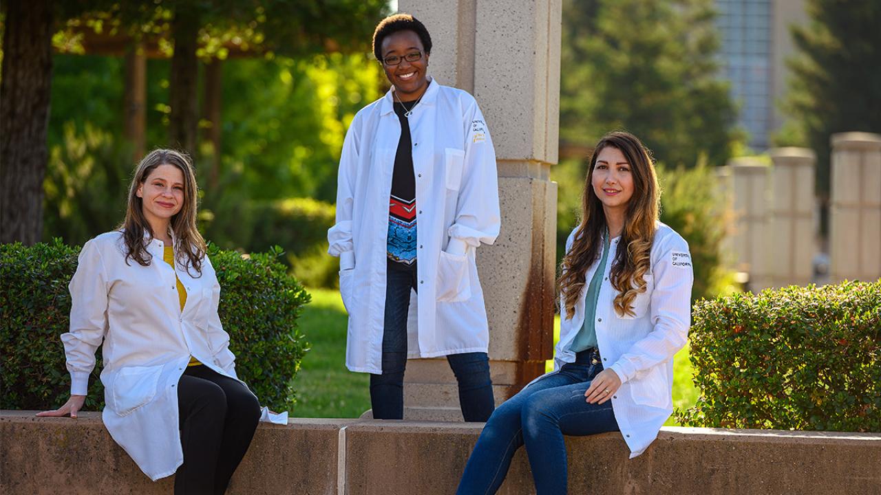 image of three female entrepreneurs wearing doctor coats sitting and standing outdoors