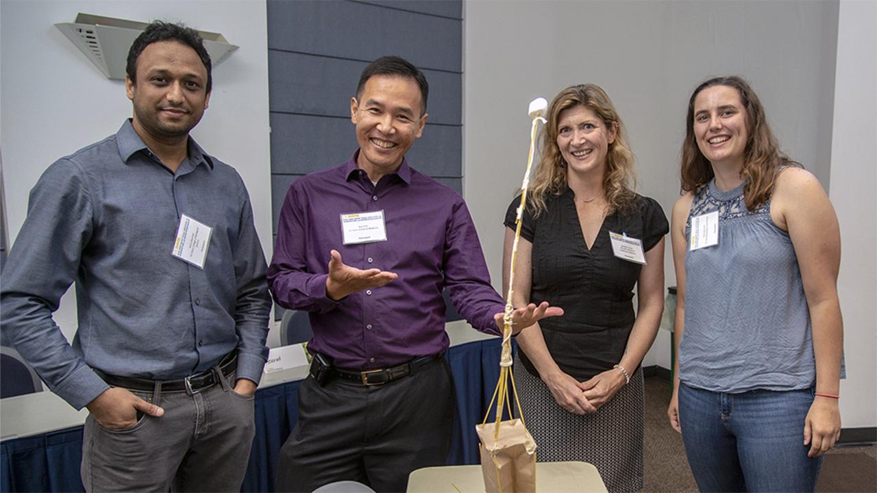image of four people standing indoors