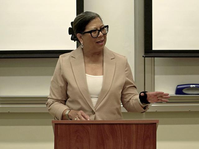Woman at a podium, speaking
