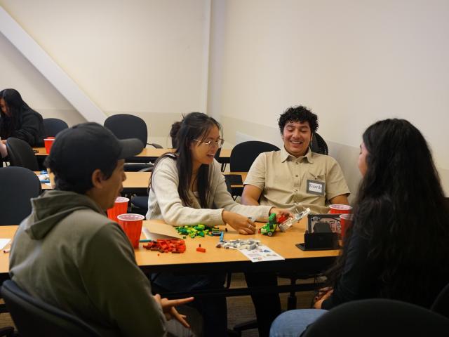 EQUIP students interacting around a table in the classroom