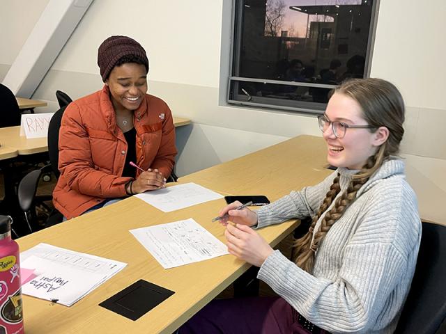 photo of two women undergraduates collaborating on a class project