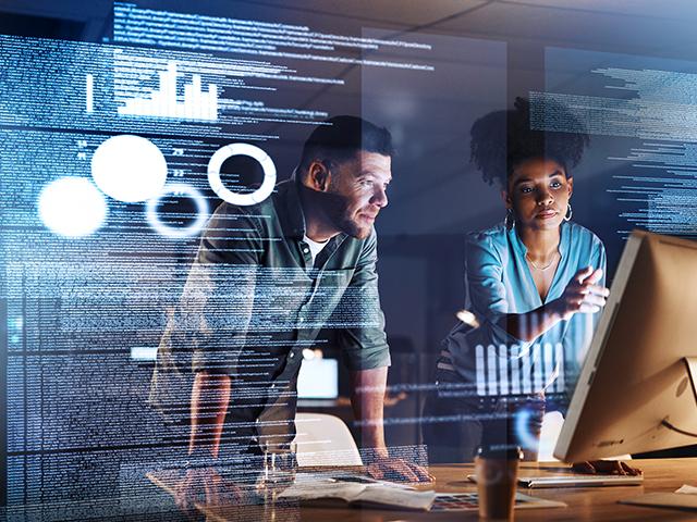 image of one male and two females pointing to computer with coding overlay