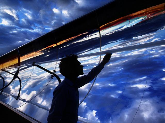 Silhouette of a man with solar panels