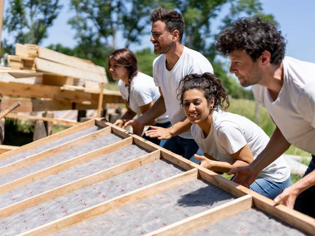 image of people building the scaffolding for a house