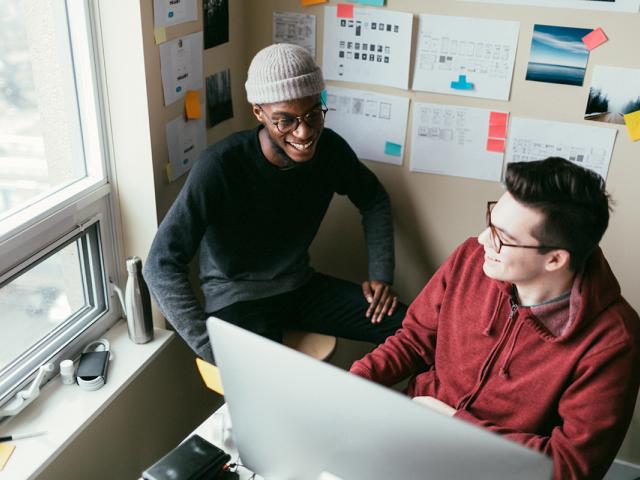 photo of two young men in a dorm room