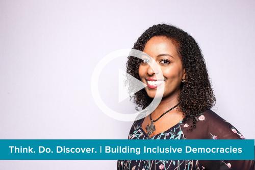 photo of a woman with overlay of a video play icon and text: Think. Do. Discover. | Building Inclusive Democracies