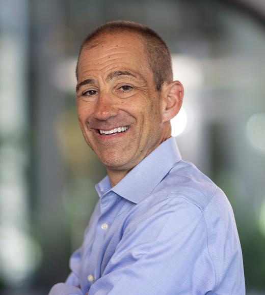 image of man standing indoors and smiling