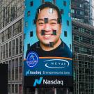 image of face on billboard on street with text "NeVap Nasdaq Entrepreneurial Cetner"