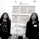 photo of four undergraduate women entrepreneurs participating in a business poster competition 