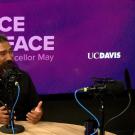 image of two people sitting and talking indoors with text 'Face to Face with Chancellor May UC Davis'
