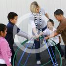 woman playing with children on playground