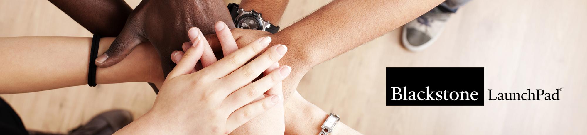 hands layered on top of one another